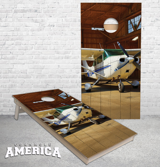 Cessna Airplane in a wooden hangar cornhole boards