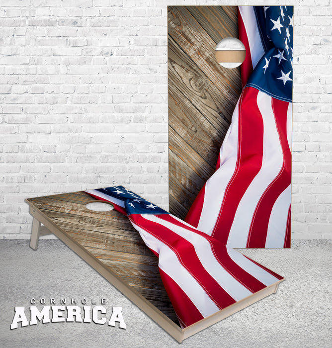 American Flag draped on rustic wood cornhole boards